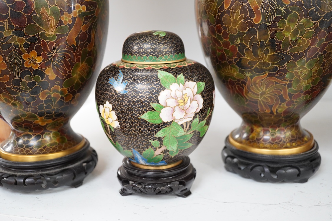 A pair of Chinese cloisonné enamel vases on stands and similar ginger jar, vases 34.6cm high including stands.